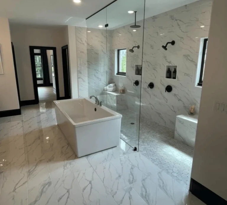 Bathroom remodel in Knoxville, TN featuring a glass-enclosed shower next to a soaking tub with modern tile accents