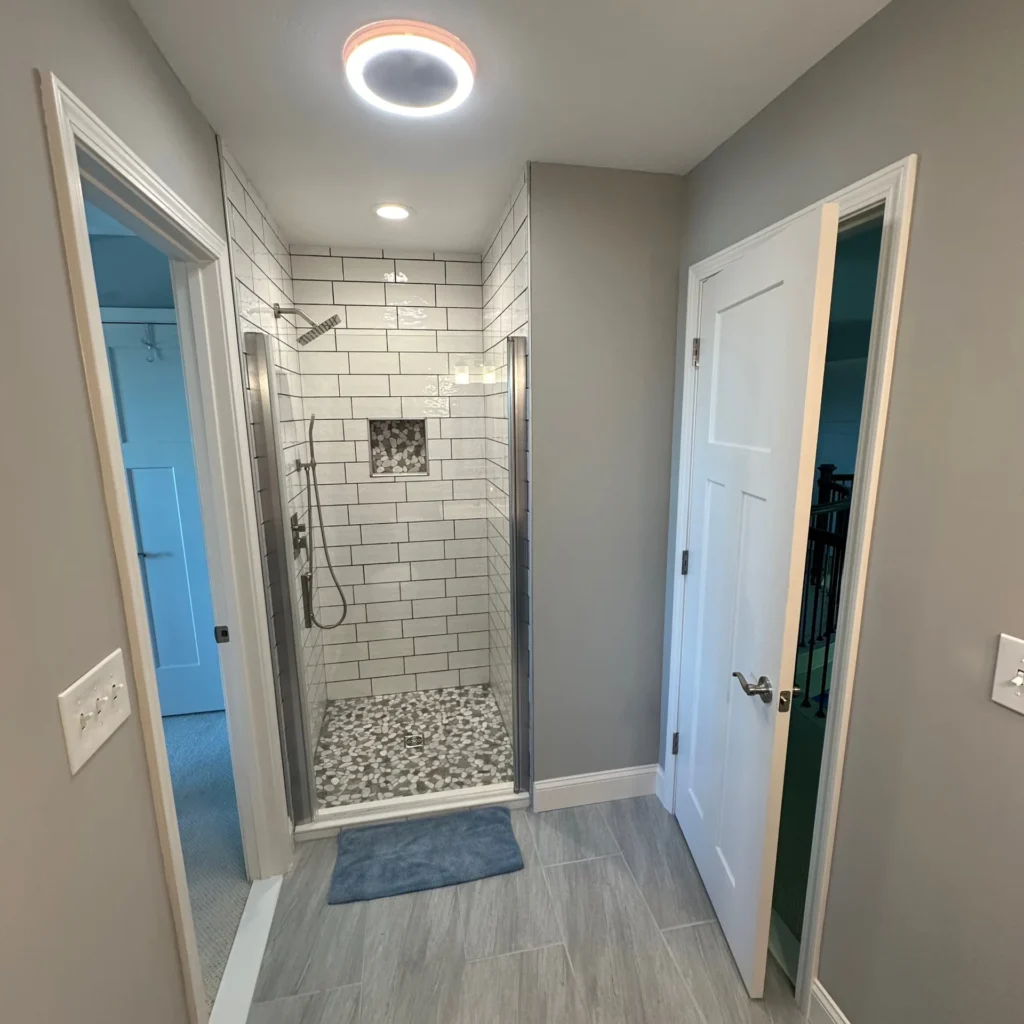 Bathroom remodel in Knoxville, TN with walk-in custom tile shower and rainfall showerhead