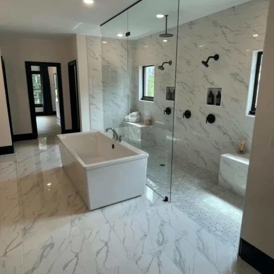 bathroom-tub-glass-shower-remodel-knoxville-tn.webp Bathroom remodel in Knoxville, TN featuring a glass-enclosed shower next to a soaking tub with modern tile accents