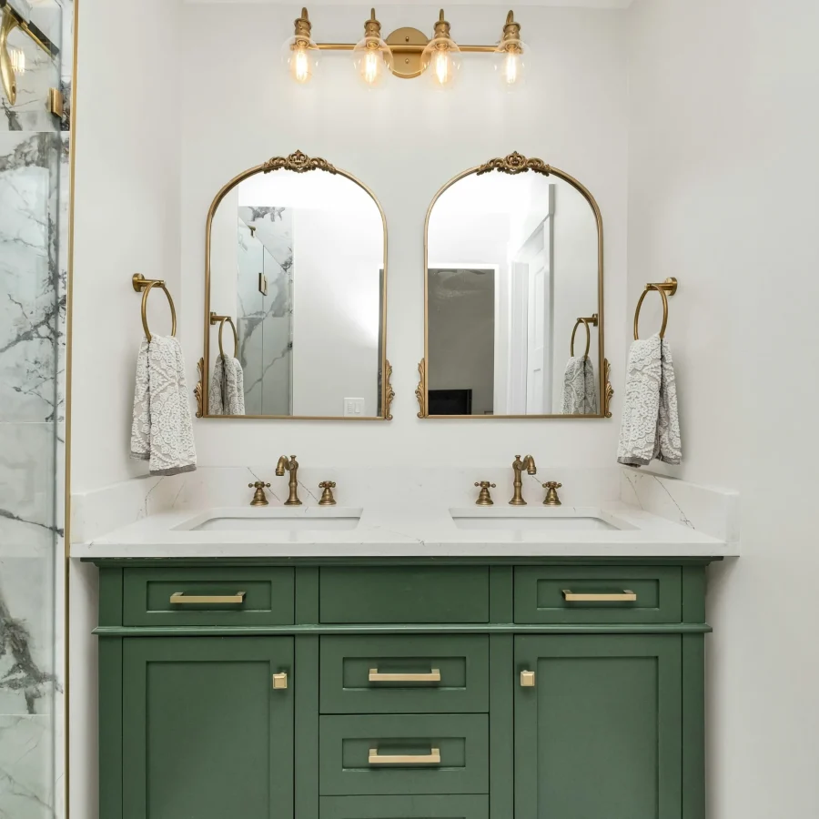 Traditional bathroom in Knoxville with double mirror vanity, marble counter, and brushed nickel hardware